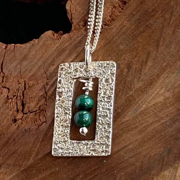 Silver framed pendants with malachite beads