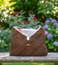 Paper raffia knit sling bag.