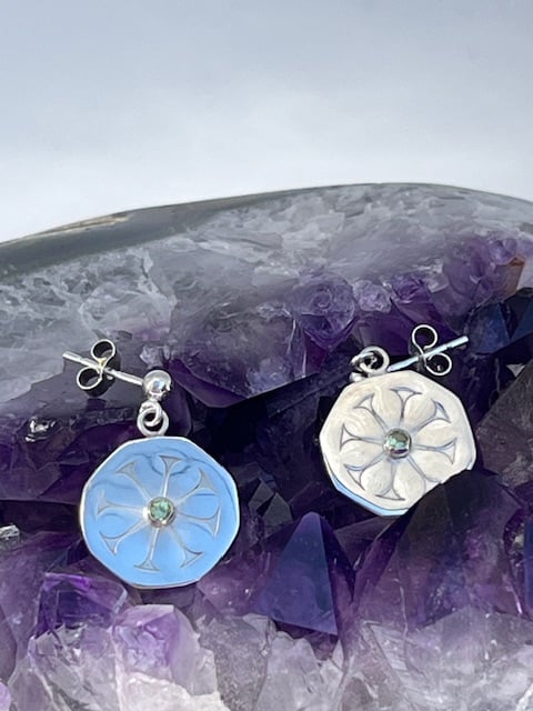 Silver patterned earrings with green sapphires