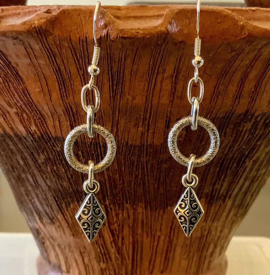 Metal frosted loop earrings with diamond metal charm