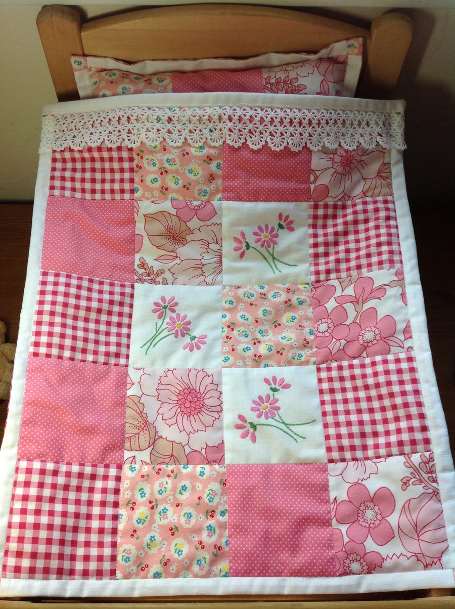 Dolls quilt and pillow in pink and white.