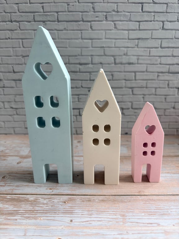 A charming trio of handcrafted pastel houses.