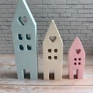 A charming trio of handcrafted pastel houses.