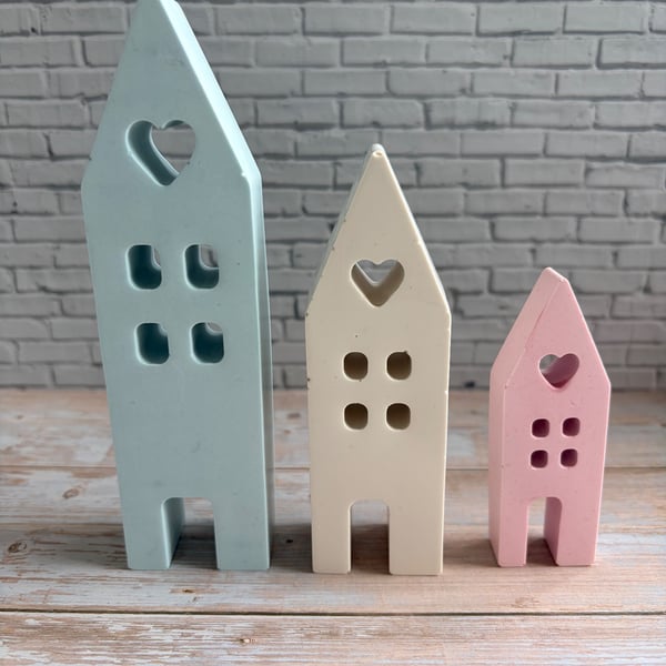 A charming trio of handcrafted pastel houses.