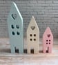 A charming trio of handcrafted pastel houses.