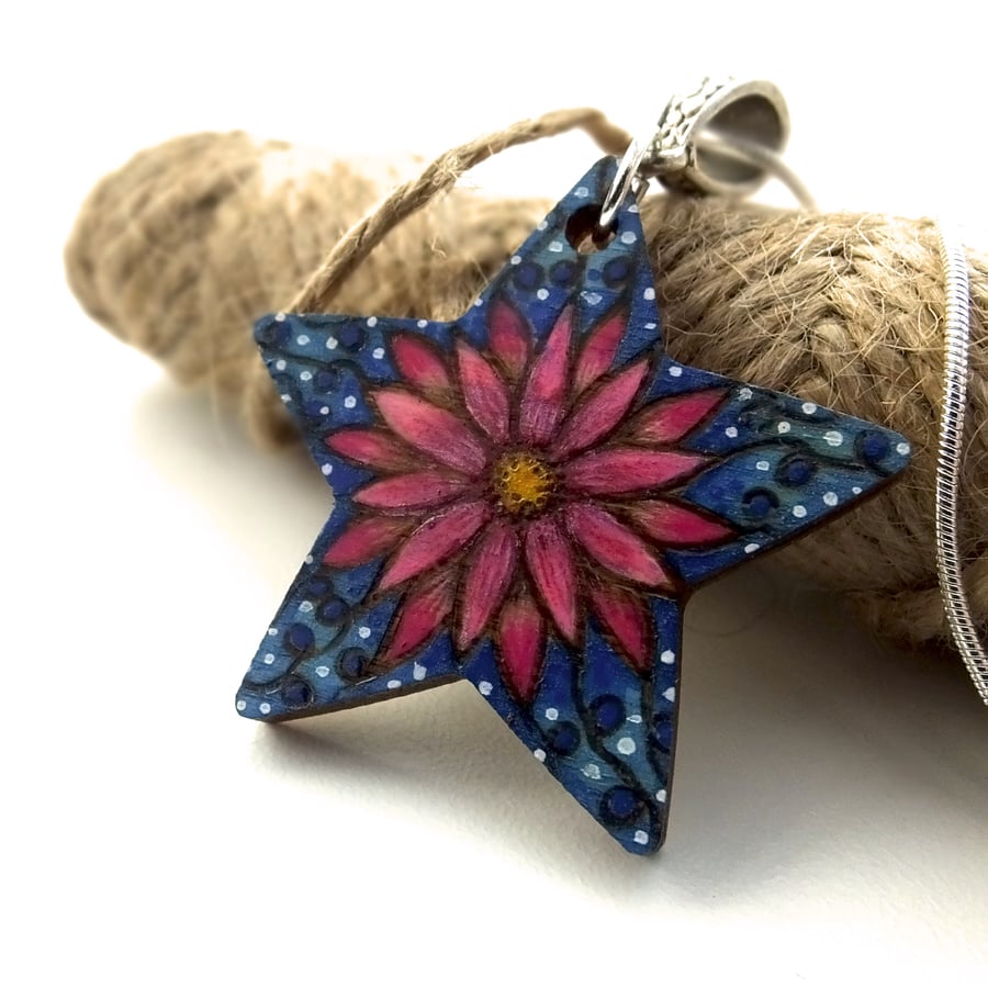 Bright pink flower star pendant with dots and swirls. Pyrography with colour.