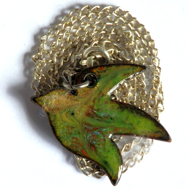 bird in flight, enamel pendant, green, red, golden brown