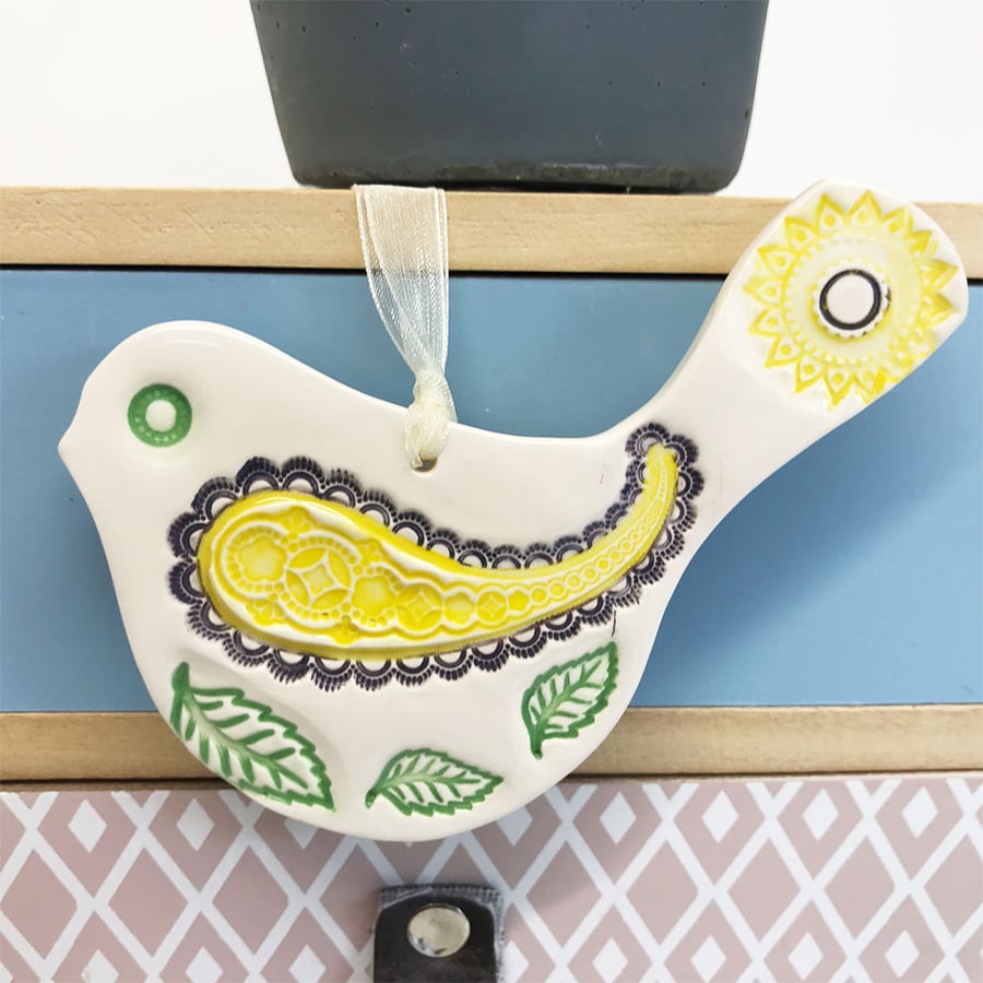 Ceramic bird decoration with patterned wing and tail 