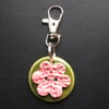 Small ceramic bag charm with flower button