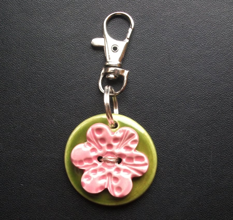 Small ceramic bag charm with flower button
