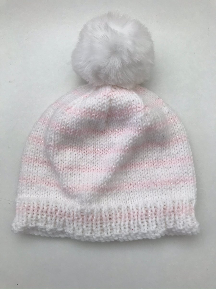 Striped hat with a faux fur pompom and a touch of sparkle