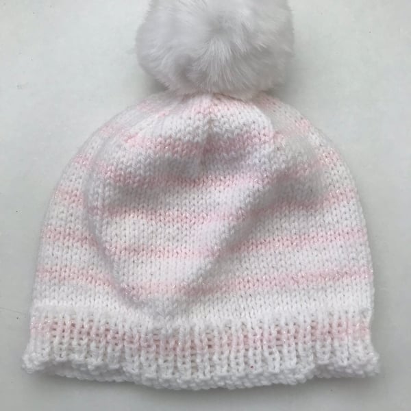Striped hat with a faux fur pompom and a touch of sparkle