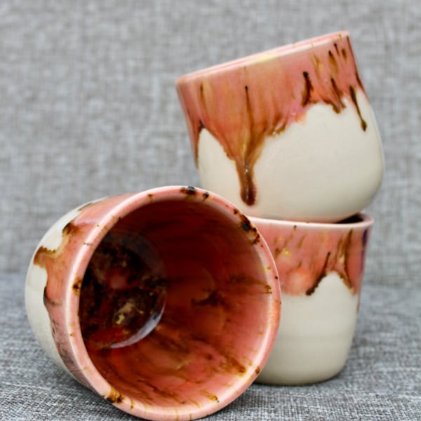 Ceramic tumbler with pink dripping glaze 