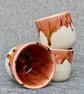 Ceramic tumbler with pink dripping glaze 