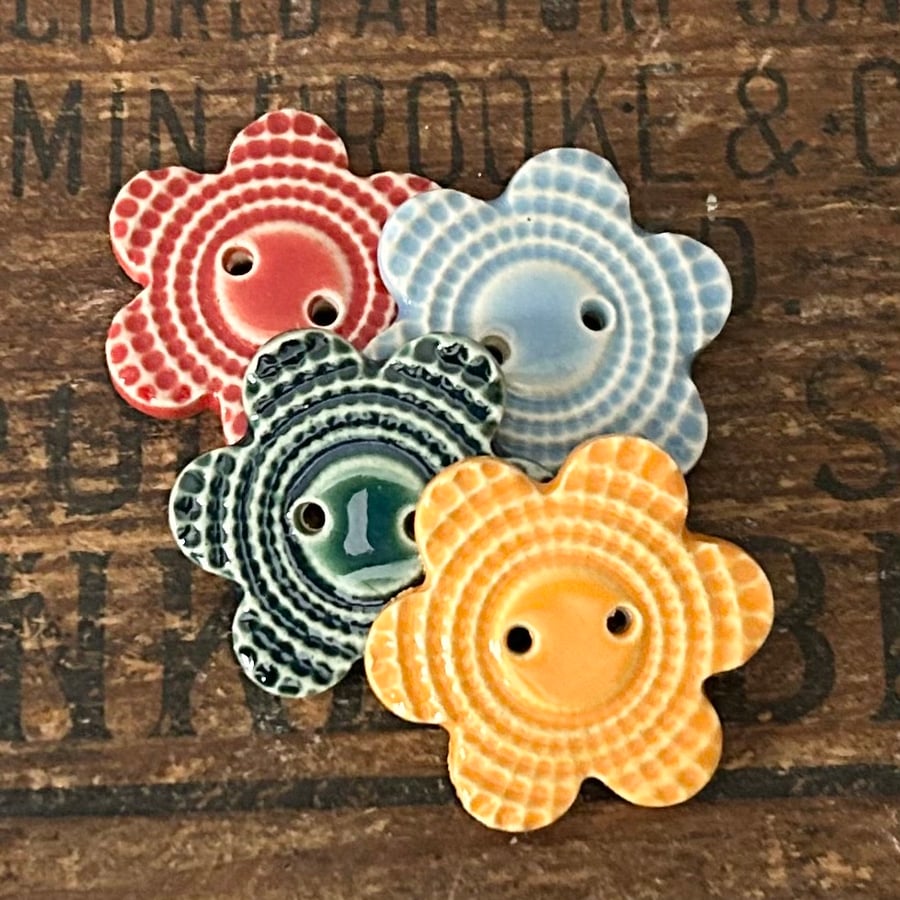 Set of four flower shaped ceramic handmade buttons 