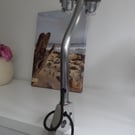 A one of a kind clamp on piston desk or table lamp