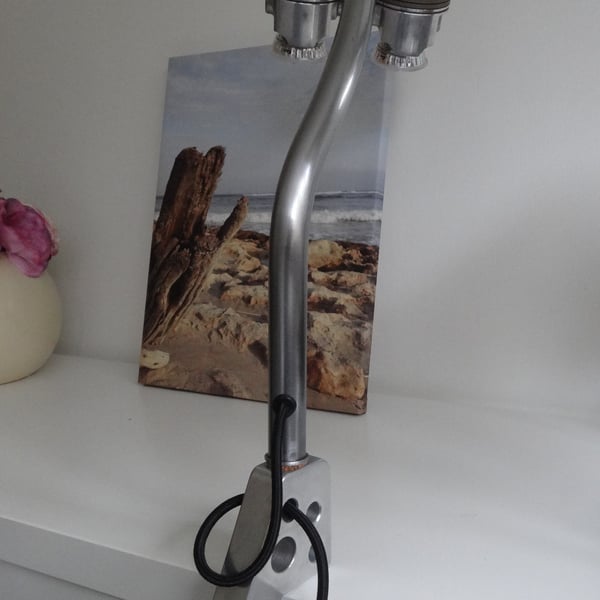 A one of a kind clamp on piston desk or table lamp