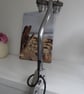A one of a kind clamp on piston desk or table lamp