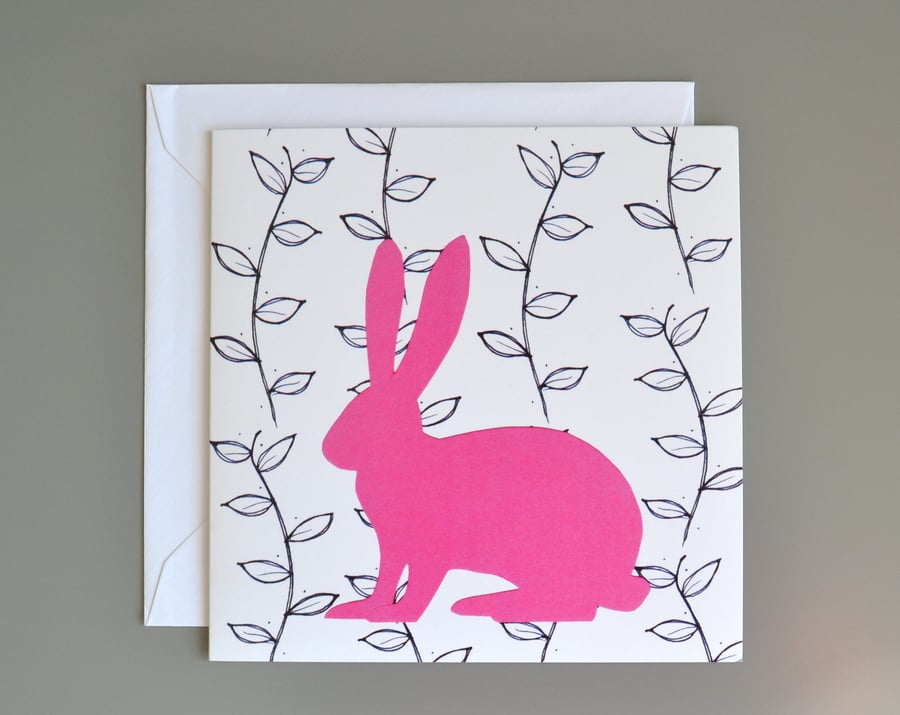 Hare in front of black and white leaf pattern blank card.