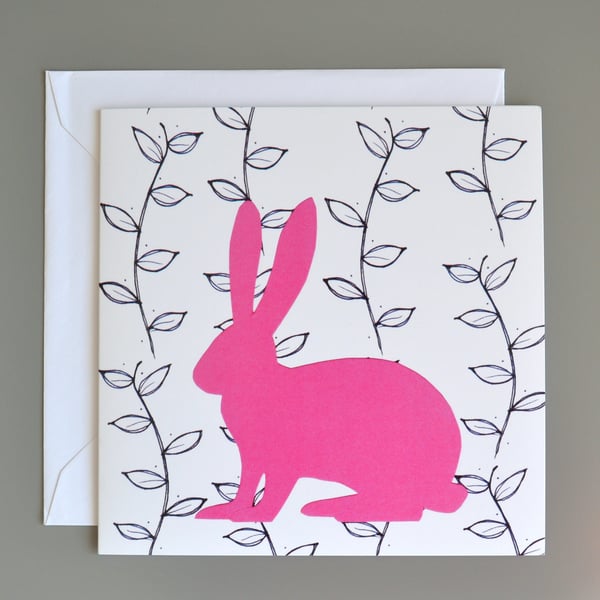 Hare in front of black and white leaf pattern blank card.