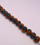 Handmade teal and mustard daisy patterned lamp work glass beads - Image 6