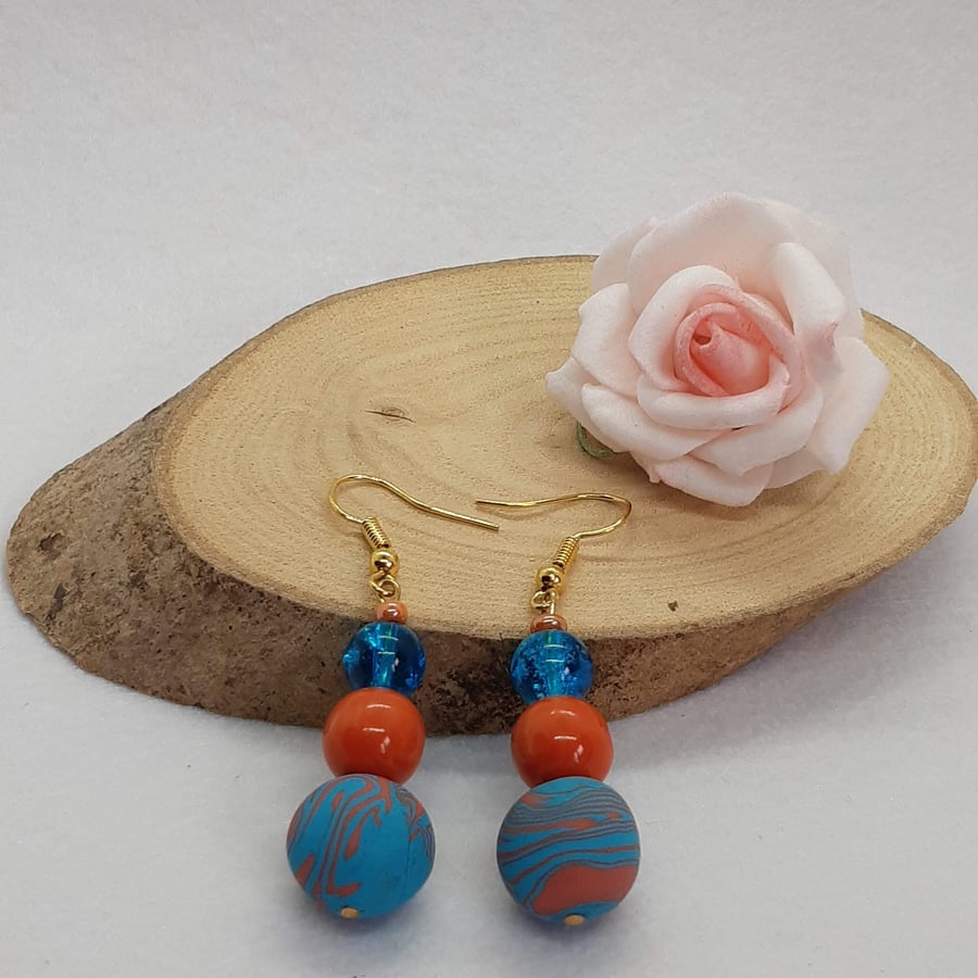 Turquoise and orange dangly earrings