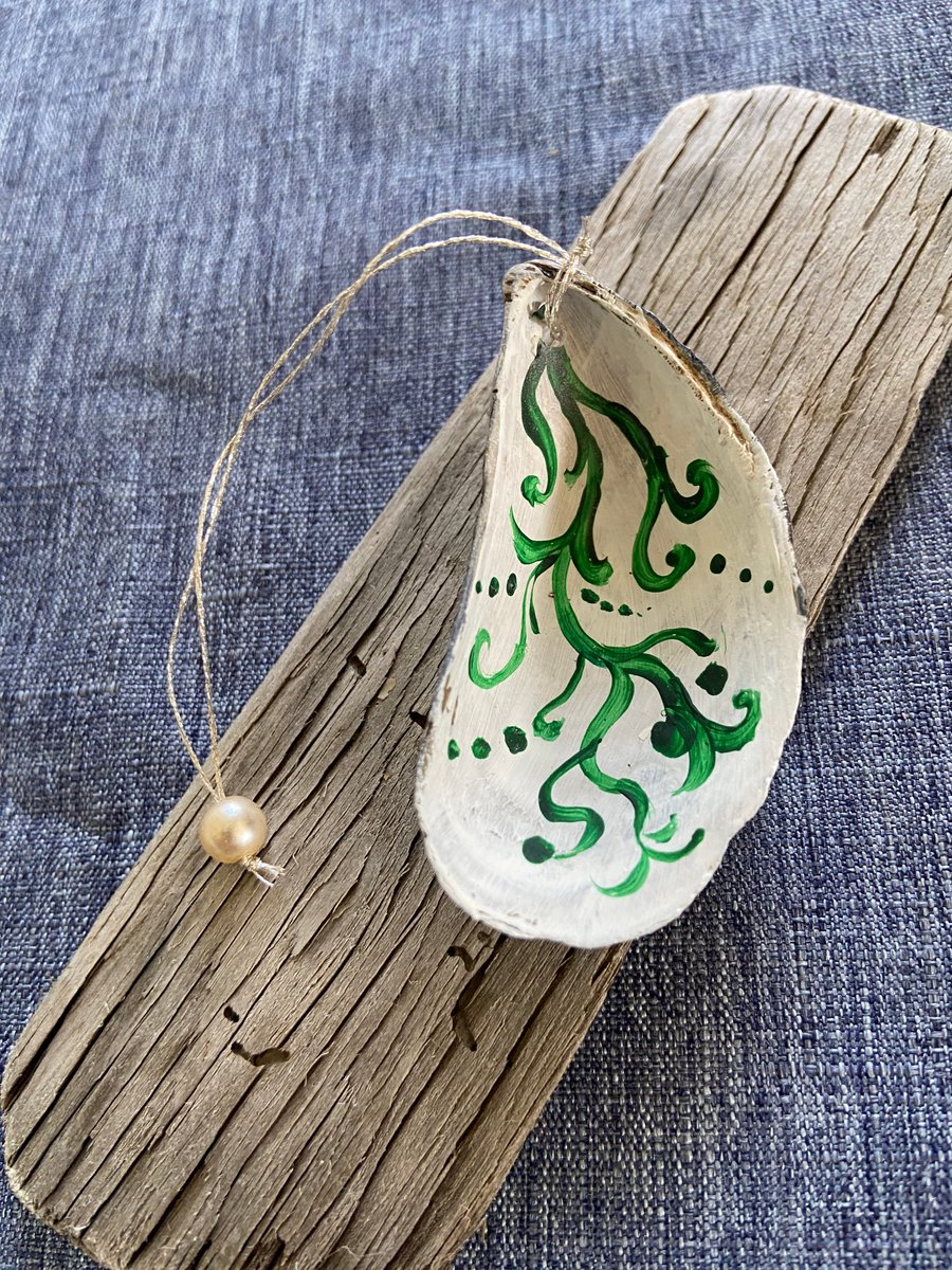 Hand painted mussel shell from an Argyll beach. With a beaded hanger.