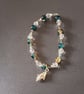Elasticated bracelet with blue and clear beads and silver shell charm  - Image 1