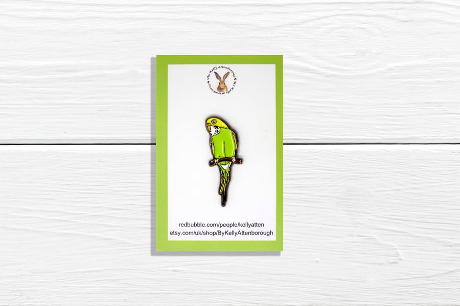 A yellow and green budgie enamel pin badge