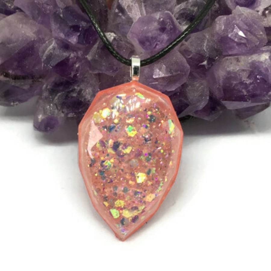 Teardrop medium sized pastel pink glitter pendant with a black cord chain.