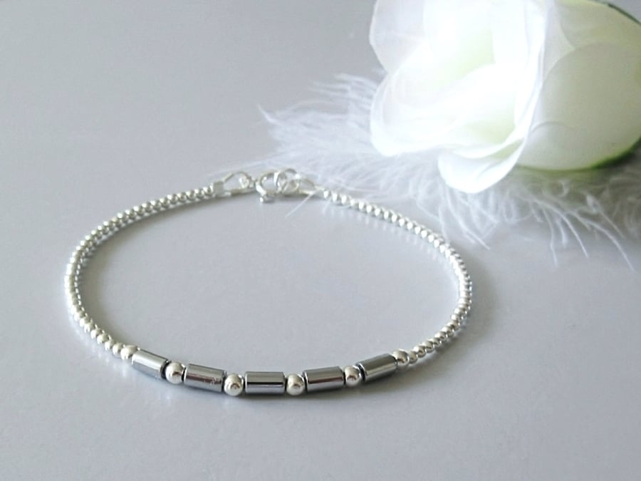 Dainty Silver Hematite Tubes Bracelet With Sterling Silver Beads - Root Chakra