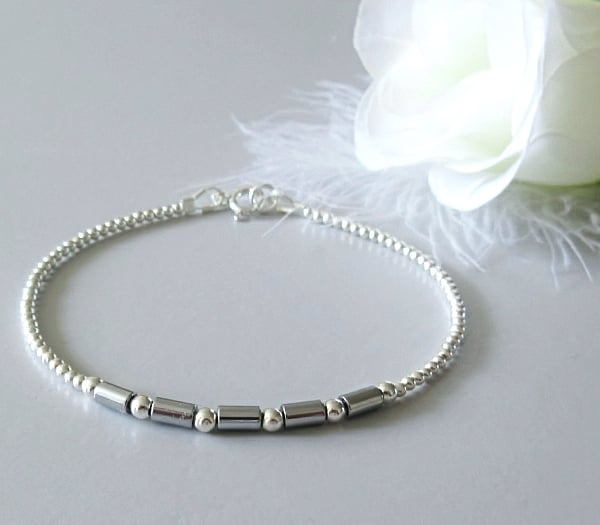 Dainty Silver Hematite Tubes Bracelet With Sterling Silver Beads - Root Chakra