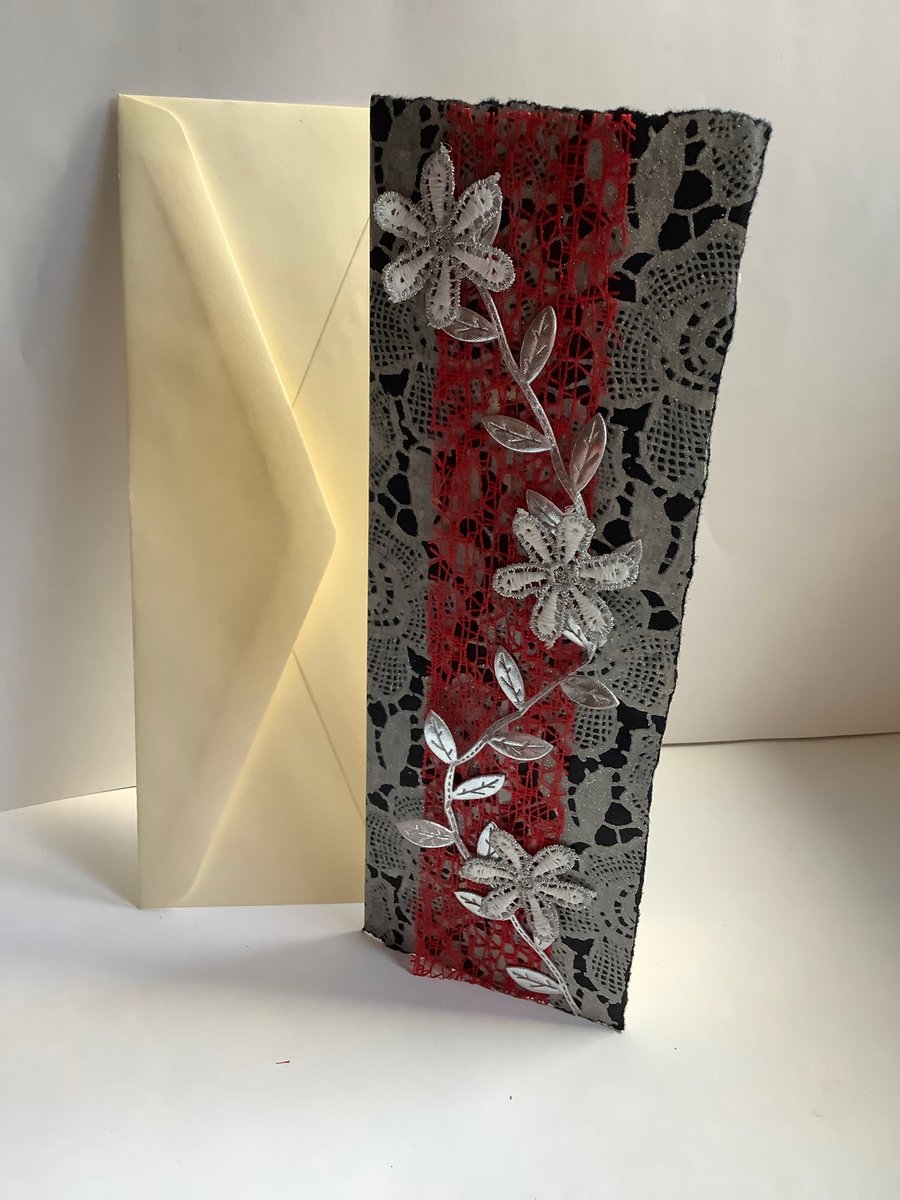 A white and silver flower card