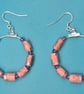 Hoop earrings threaded with with dusky pink paper beads