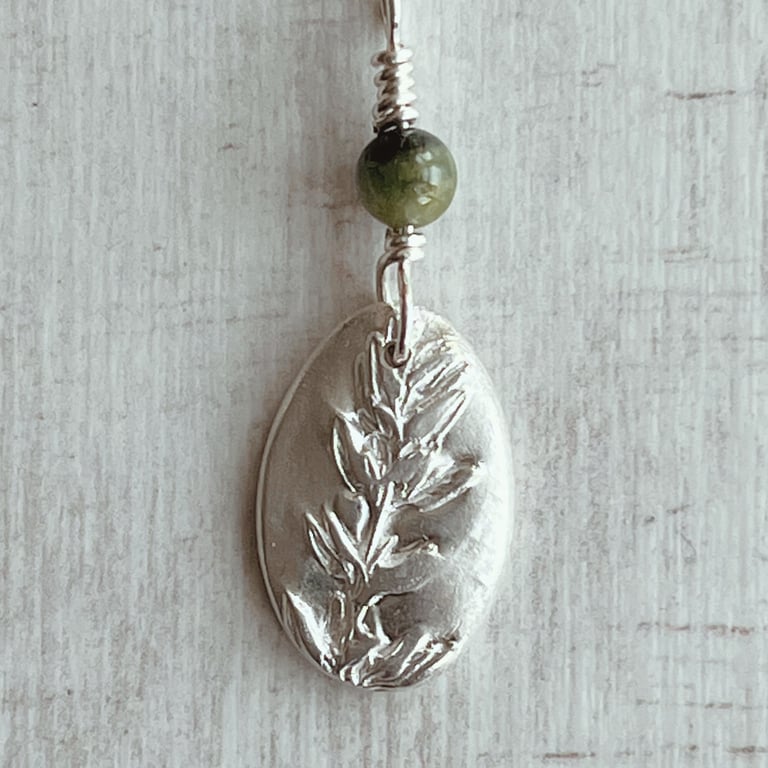 Silver botanical necklace with thyme and a tourmaline bead on a silver chain
