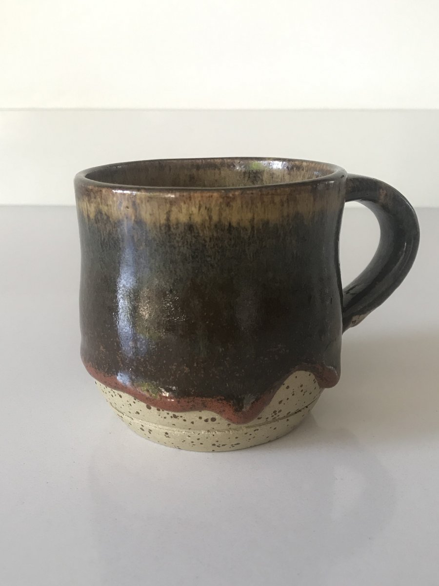Stoneware pottery mug glazed in browns, greys, reds