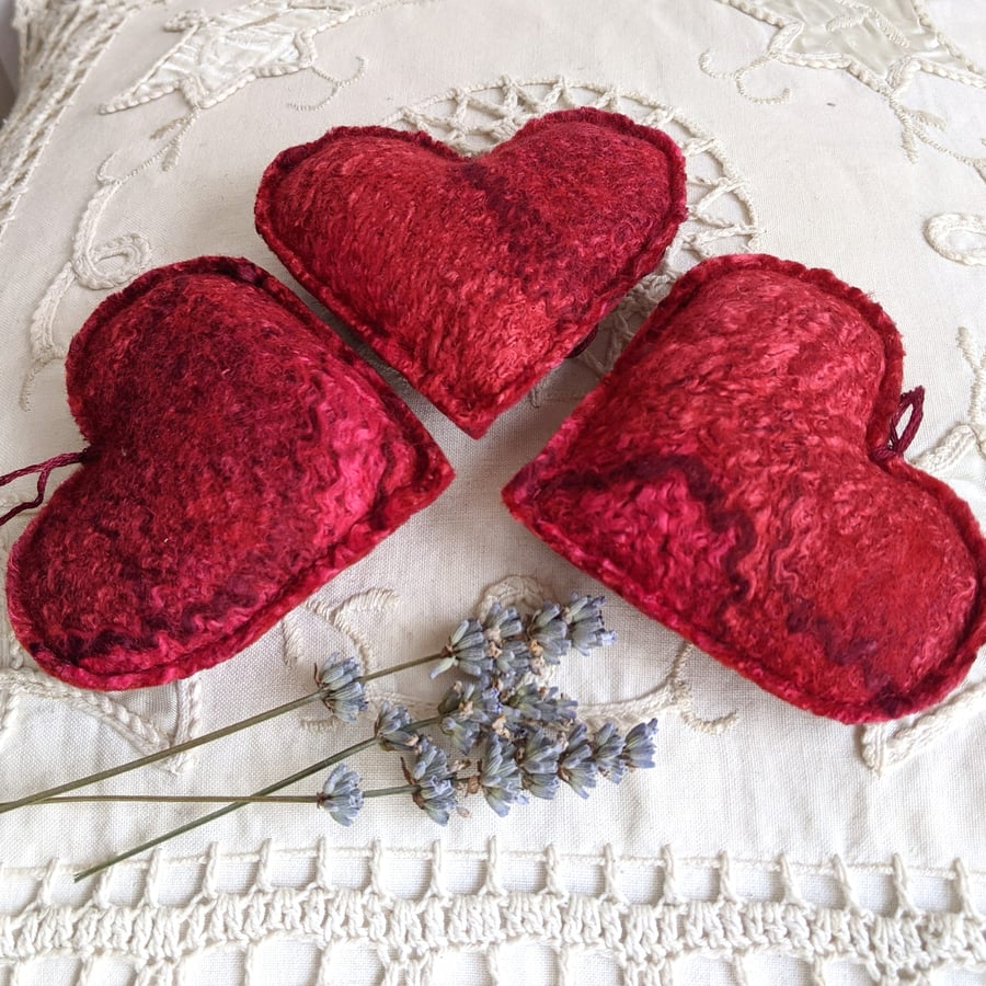 Three lavender hearts in shades of red