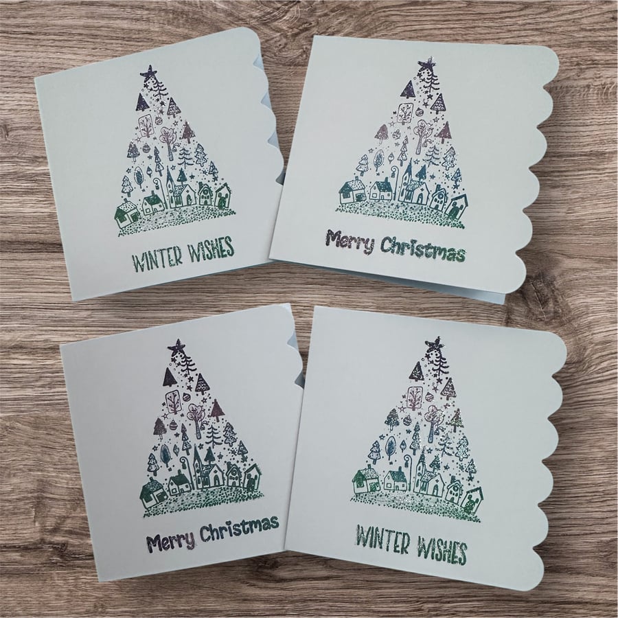 Pack of 4 glittery christmas tree village cards in subtle pastel colours 