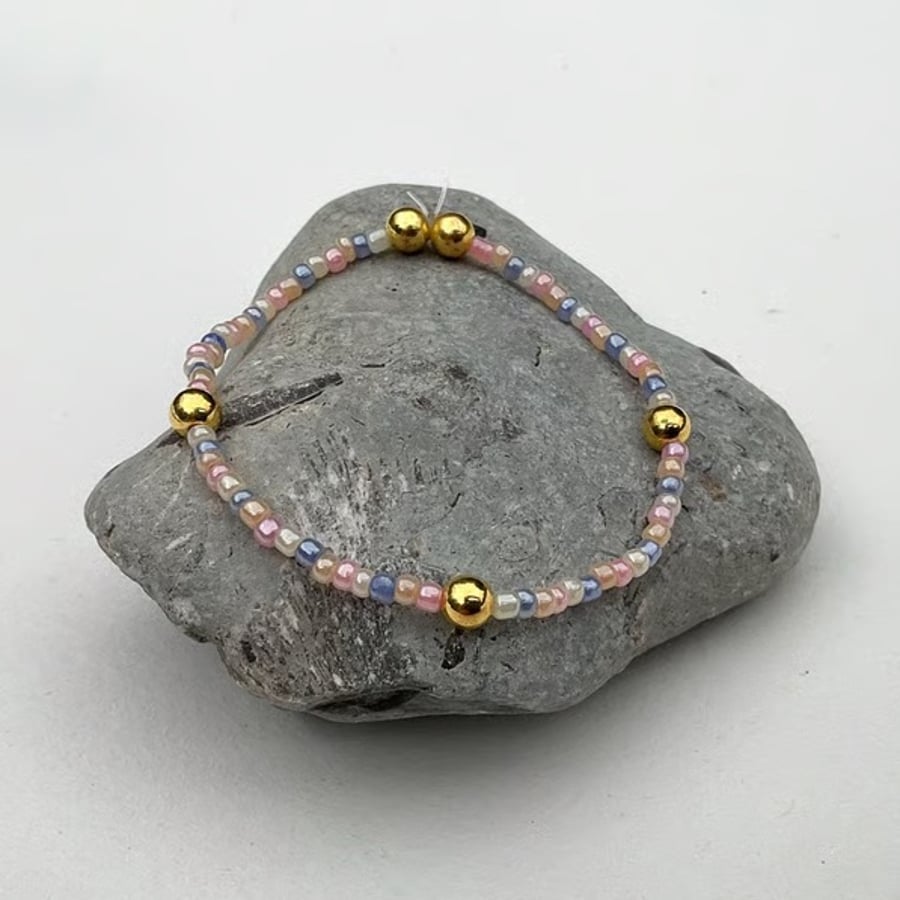 Beaded bracelet handmade in muted rainbow and gold