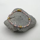 Beaded bracelet handmade in muted rainbow and gold