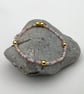 Beaded bracelet handmade in muted rainbow and gold