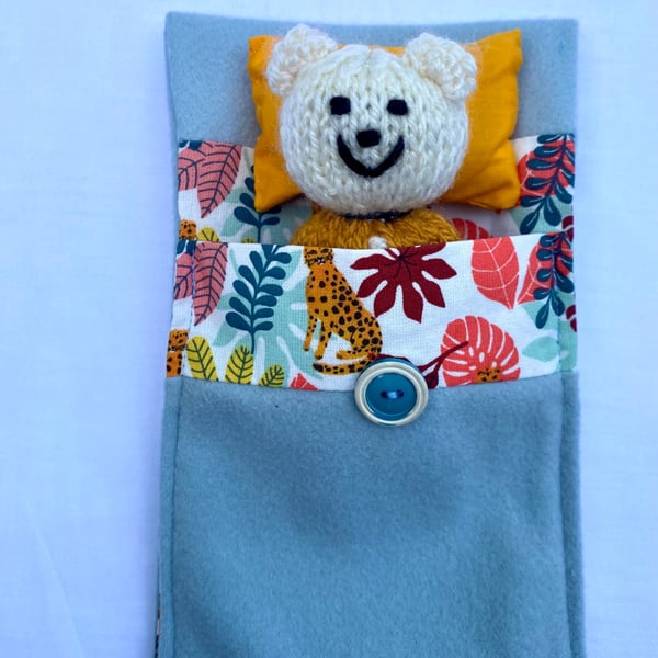 Hand knitted ted in a bed, companion bear