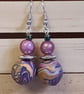 Handmade dangly polymer clay earrings in a colourful swirl design - Image 4