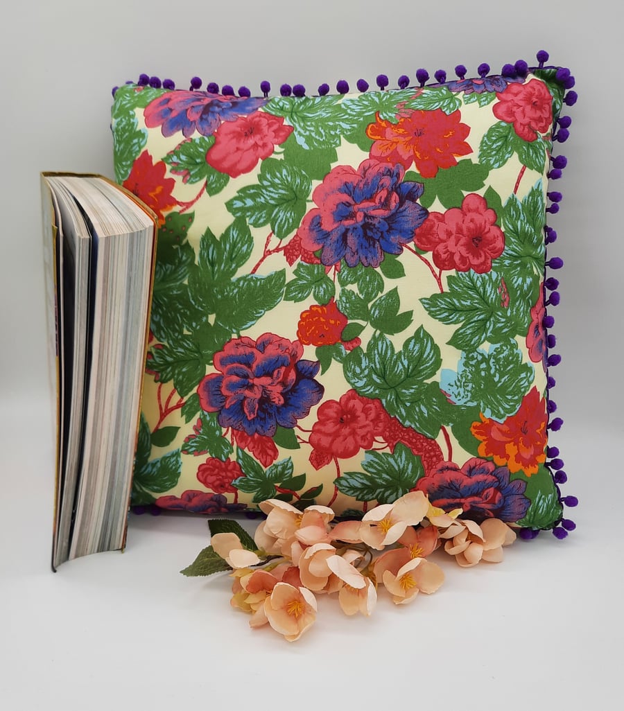 Cushion 13" floral with purple bobble trim. 