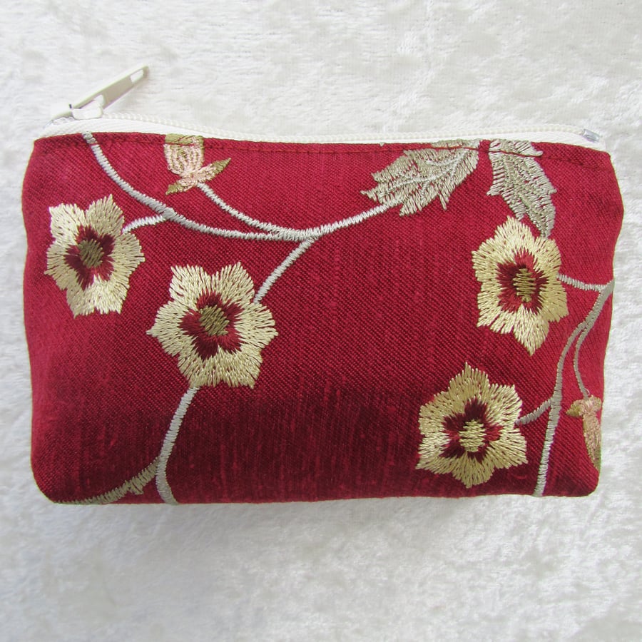 Small purse in red with yellow and green floral pattern