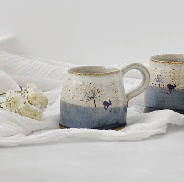Handmade blue and white ceramic mug with running hare - stoneware pottery