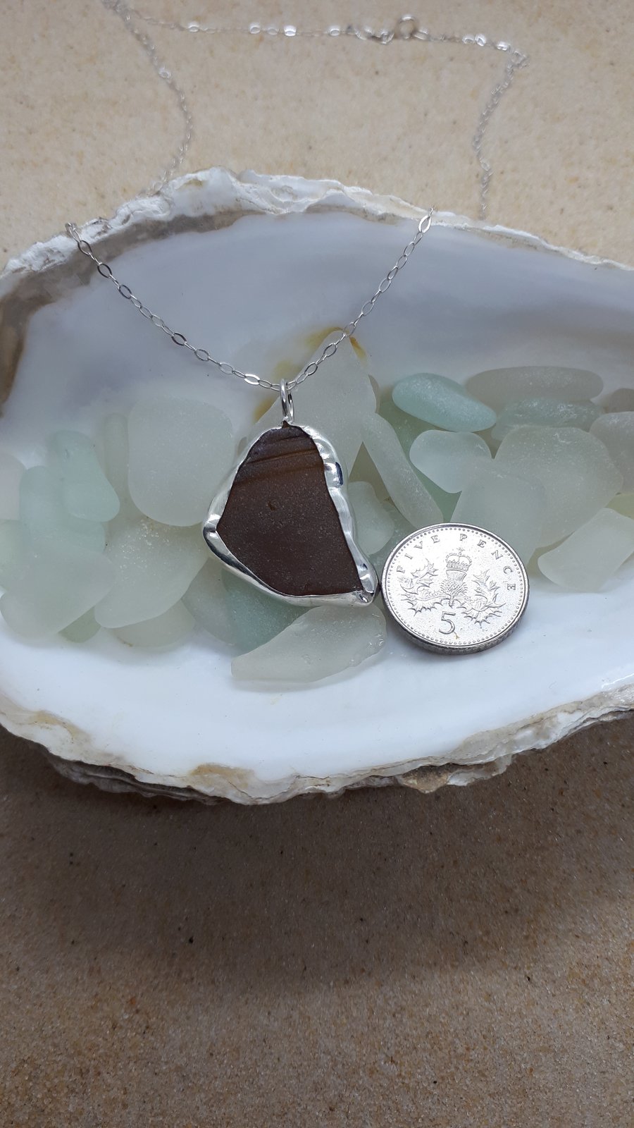 Dark brown sea glass and silver pendant 