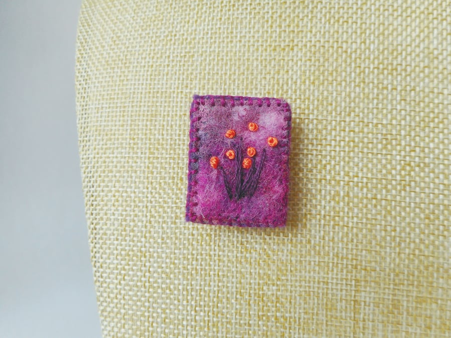 Needle felted and hand embroidered brooch in purple with orange flowers