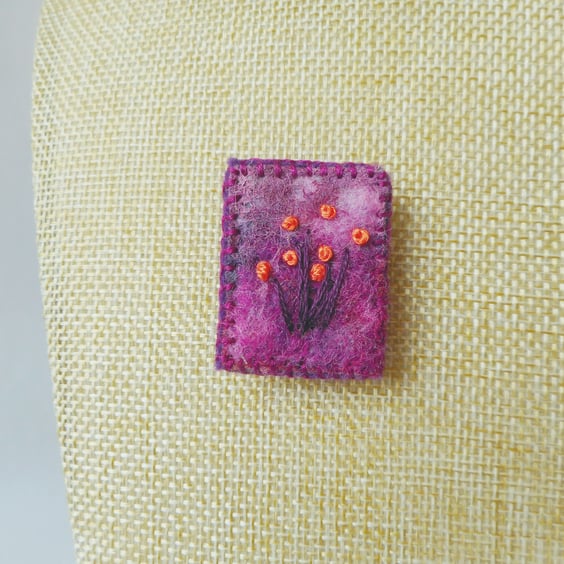 Needle felted and hand embroidered brooch in purple with orange flowers