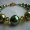 GREEN AND GOLD HEART BRACELET.  168